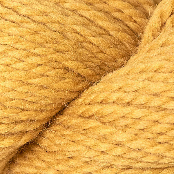 Close up on skein of Berroco Ultra Alpaca Chunky yarn in mustard yellow. 