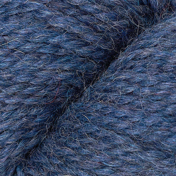 Close up on skein of Berroco Ultra Alpaca Chunky yarn in dark heathered blue. 