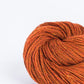 Pumpkin orange ball of Brooklyn Tweed Loft yarn. 