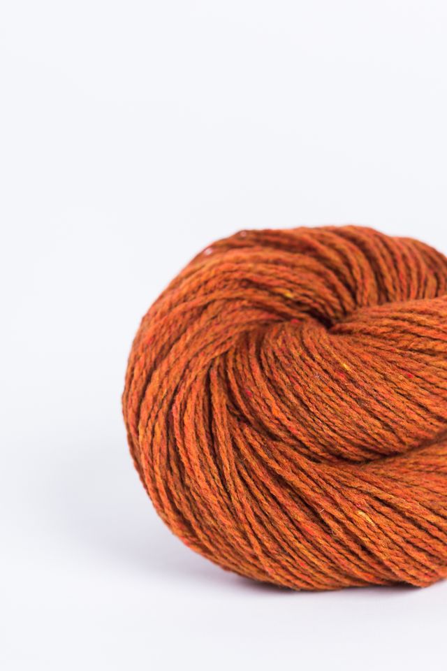 Pumpkin orange ball of Brooklyn Tweed Loft yarn. 