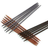 Three sets of five double pointed needles in shades of brown. 