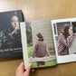 Yuco Sakamoto’s My Fair Isle Journey book, lying open to a photo of people wearing colorful fair isle garments. 