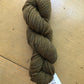 1 skein of dark moss green Fibre Co. Acadia yarn. 