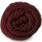 Close up on a burgundy skein of Brown Sheep Cotton Fleece yarn. 