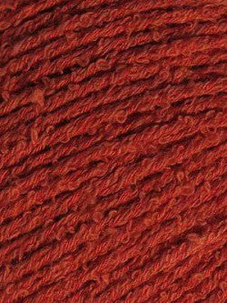 Close-up image of bambouclé yarn from Elsebeth Lavold in warm red.