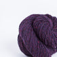 Dark purple ball of Brooklyn Tweed Loft yarn. 