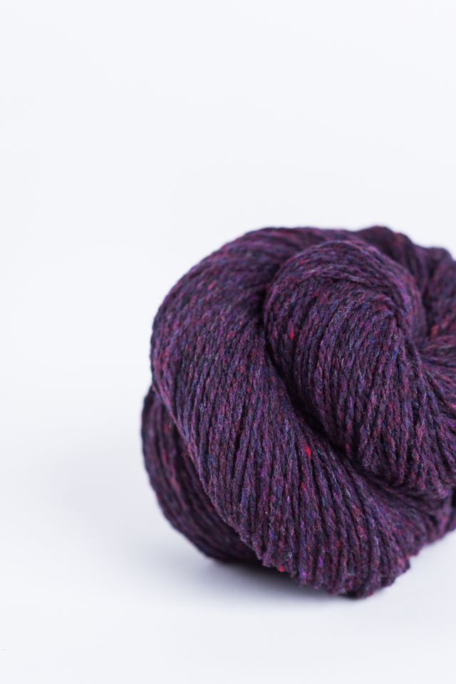 Dark purple ball of Brooklyn Tweed Loft yarn. 