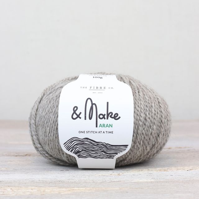 Light heathered gray ball of Fibre Co. & Make Aran yarn. 