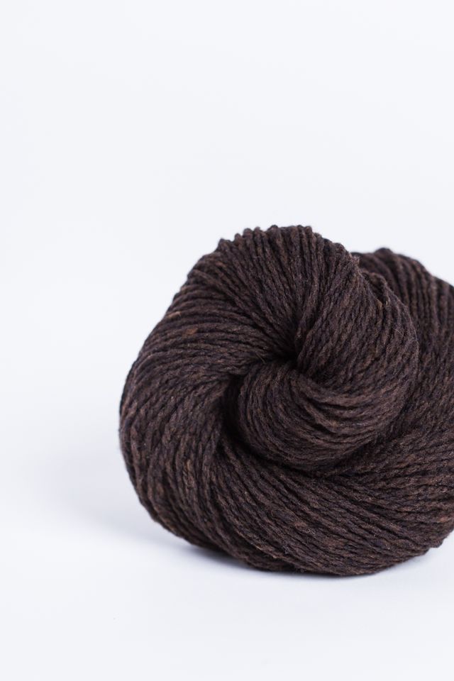 Dark brown ball of Brooklyn Tweed Loft yarn. 