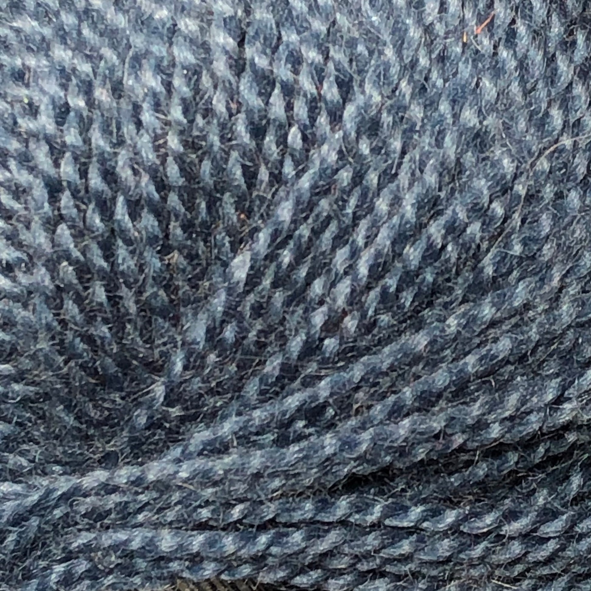 Close up on a ball of denim blue Jo Sharp Alpaca Kid Lustre yarn. 