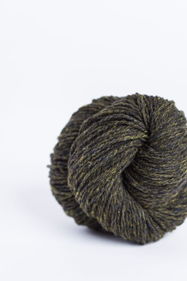 Dark moss green ball of Brooklyn Tweed Loft yarn. 