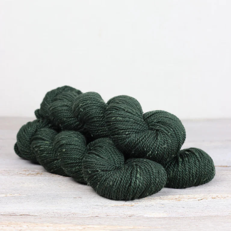 3 skeins of forest green Fibre Co. Acadia yarn. 