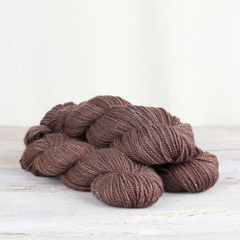 3 skeins of medium brown Fibre Co. Acadia yarn. 