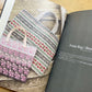 Yuco Sakamoto’s My Fair Isle Journey book, lying open to a photo of colorful fair isle totes. 