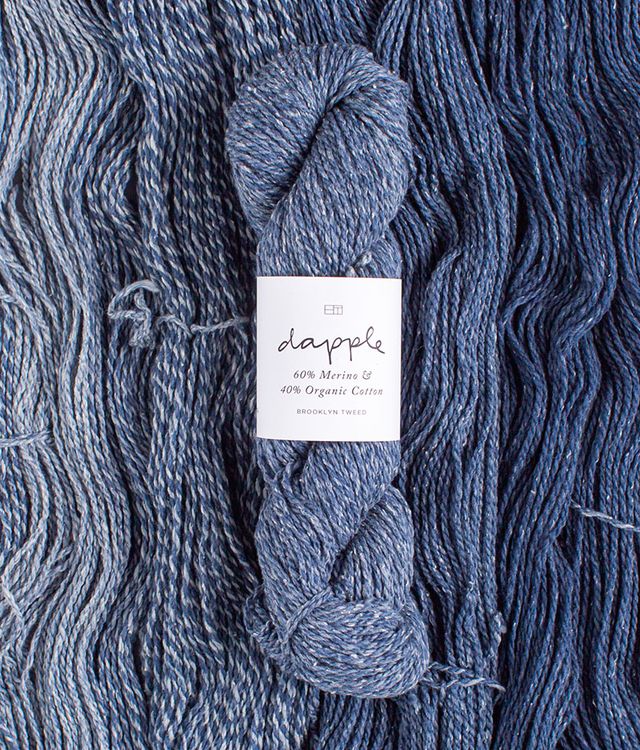 Skeins of denim blue Brooklyn Tweed Dapple yarn. 