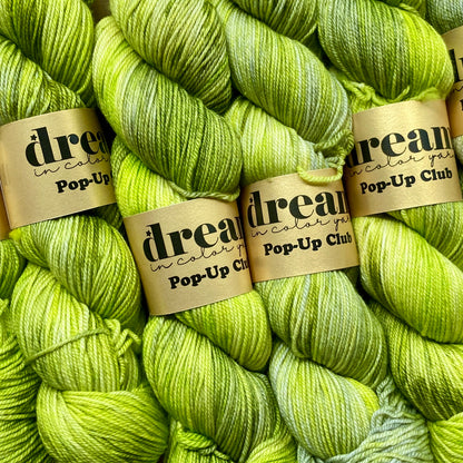 Neon green skeins of Dream in Color Smooshy Cashmere yarn. 