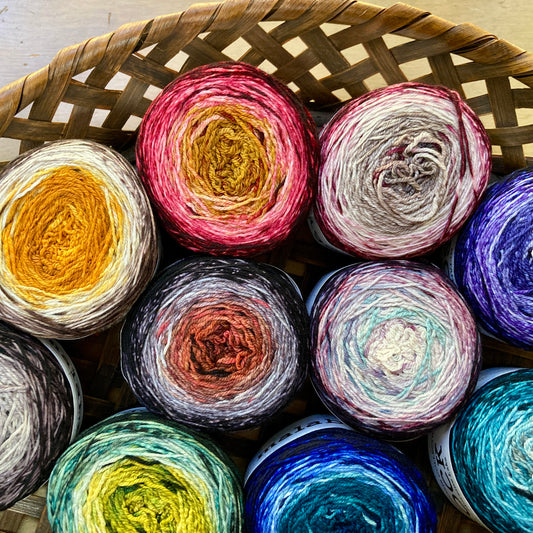 Basket full of colorful Malabrigo Metamorphosis Sock yarn. 