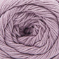 Close up on a semisolid ball of orchid purple Cascade Botanika yarn. 