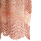 Close up on pink hand knit shawl.