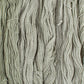 Skeins of light sage green Brooklyn Tweed Dapple yarn. 