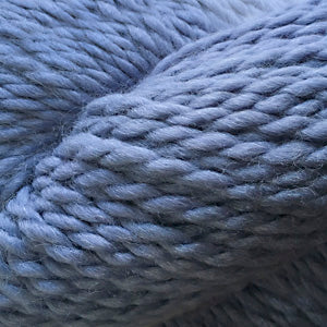 Close up on a skein of periwinkle Cascade Baby Alpaca Chunky yarn. 