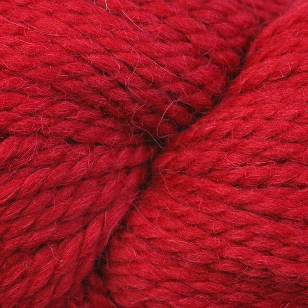 Close up on skein of Berroco Ultra Alpaca Chunky yarn in 7234 Cardinal red. 