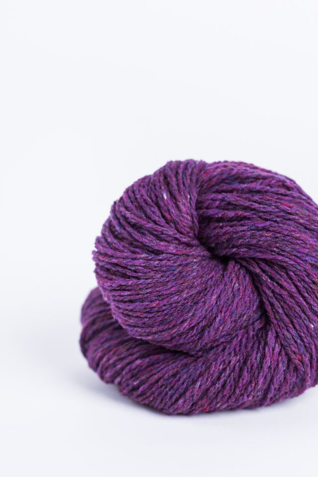 Purple ball of Brooklyn Tweed Loft yarn. 