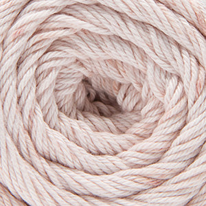 Close up on a speckled ball of white and pink Cascade Botanika yarn. 