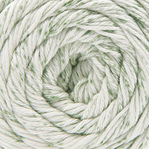 Close up on a speckled ball of white and green Cascade Botanika yarn. 