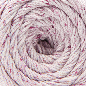 Close up on a speckled ball of white and burgundy Cascade Botanika yarn. 