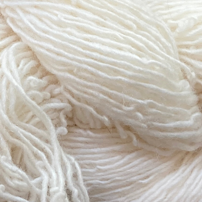 Close up on a bright white skein of Briggs & Little Sport yarn. 