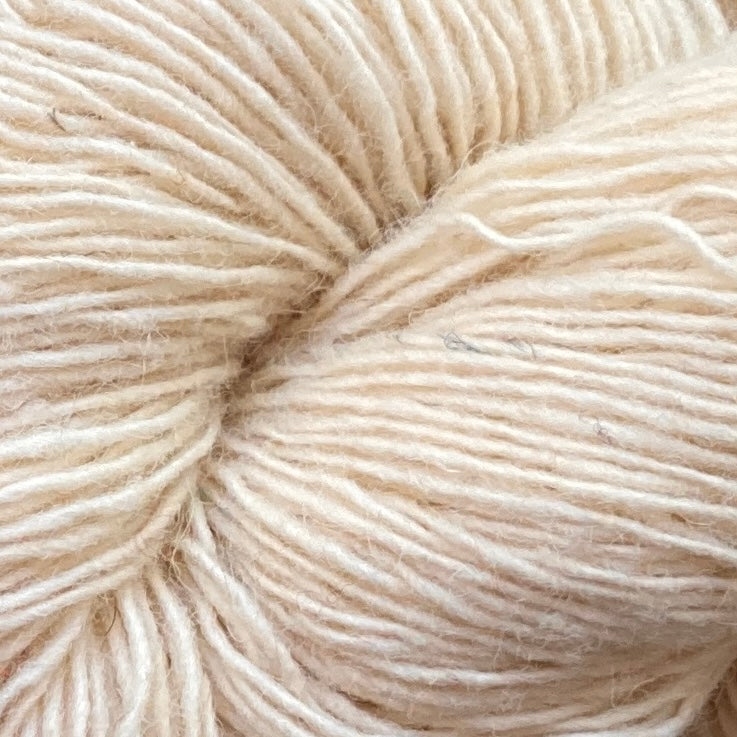 Close up on an ivory skein of Briggs & Little Sport yarn. 