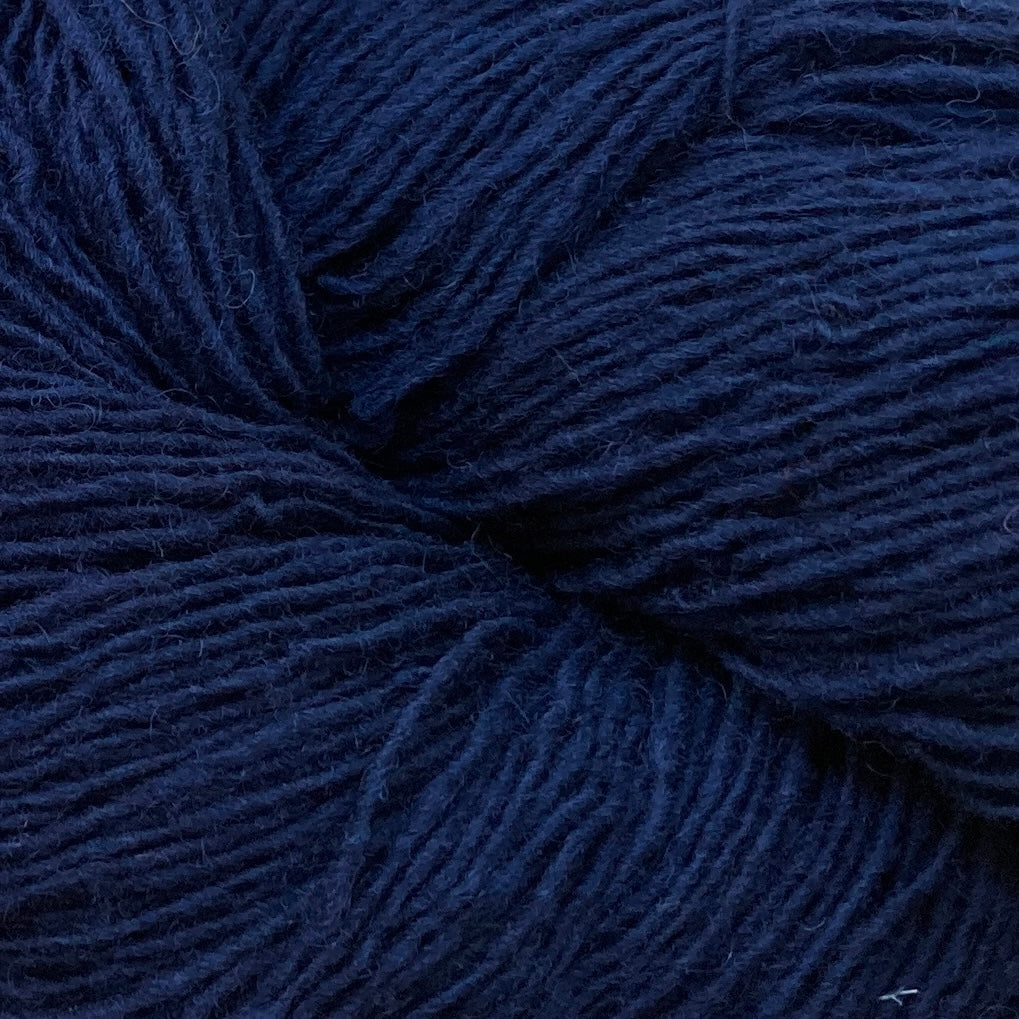 Close up on a navy blue skein of Briggs & Little Sport yarn. 