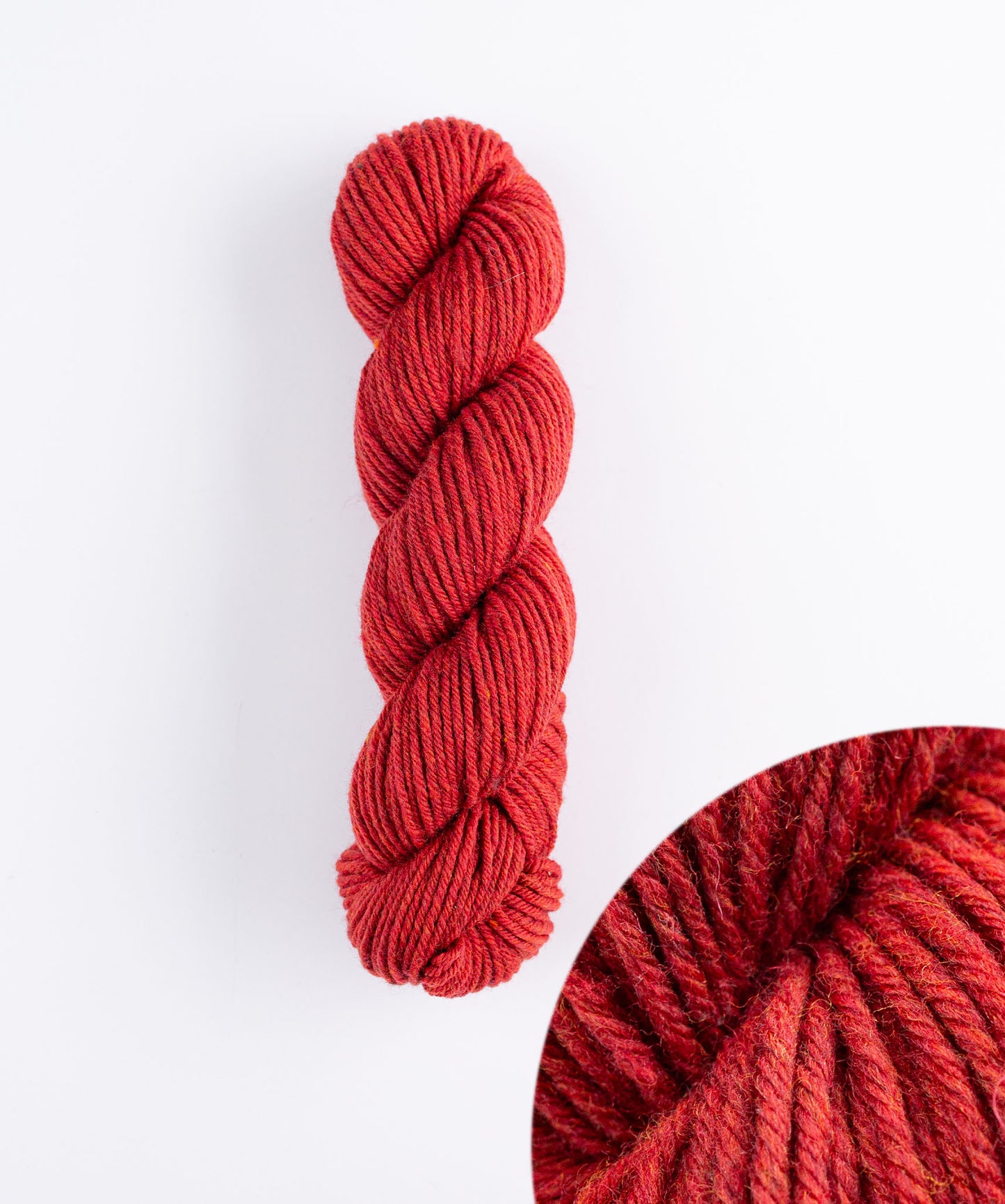 Skein of fiery red Brooklyn Tweed Imbue Worsted yarn. 