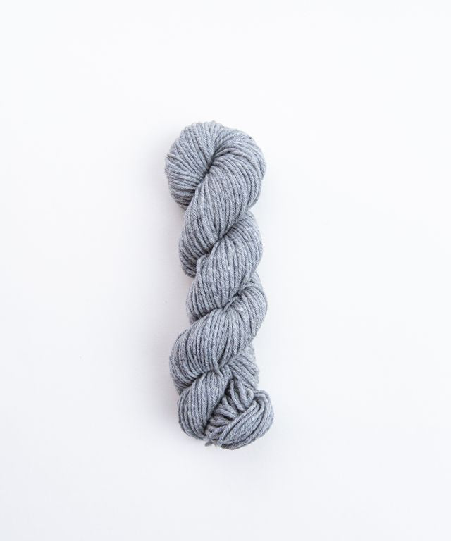 Skein of heathered gray Brooklyn Tweed Imbue Worsted yarn. 