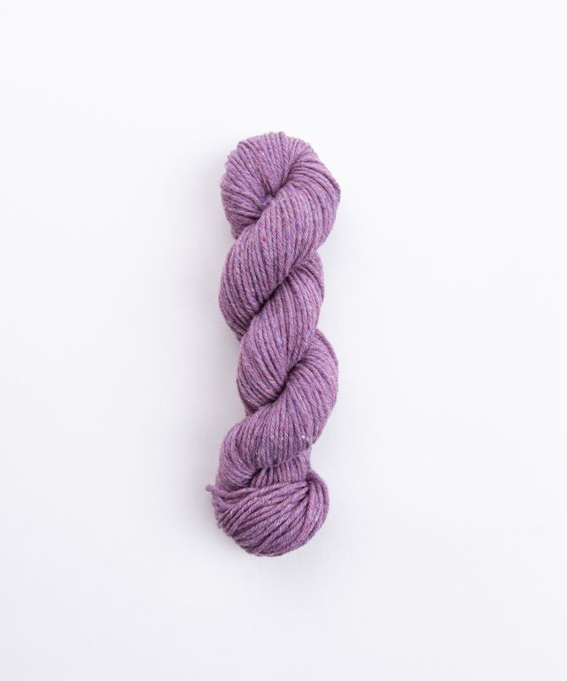 Skein of heathered lavender Brooklyn Tweed Imbue Worsted yarn. 