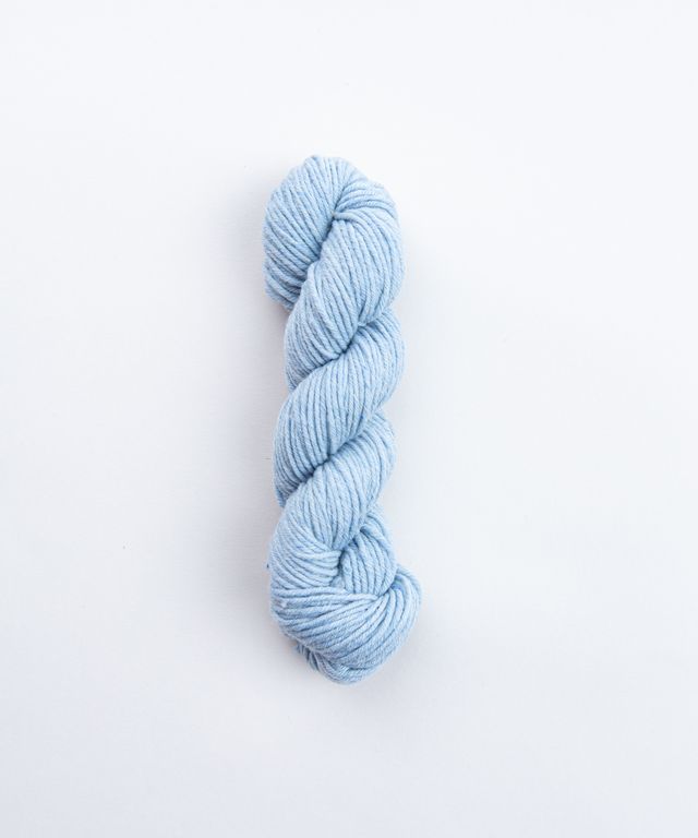 Skein of heathered light blue Brooklyn Tweed Imbue Worsted yarn. 