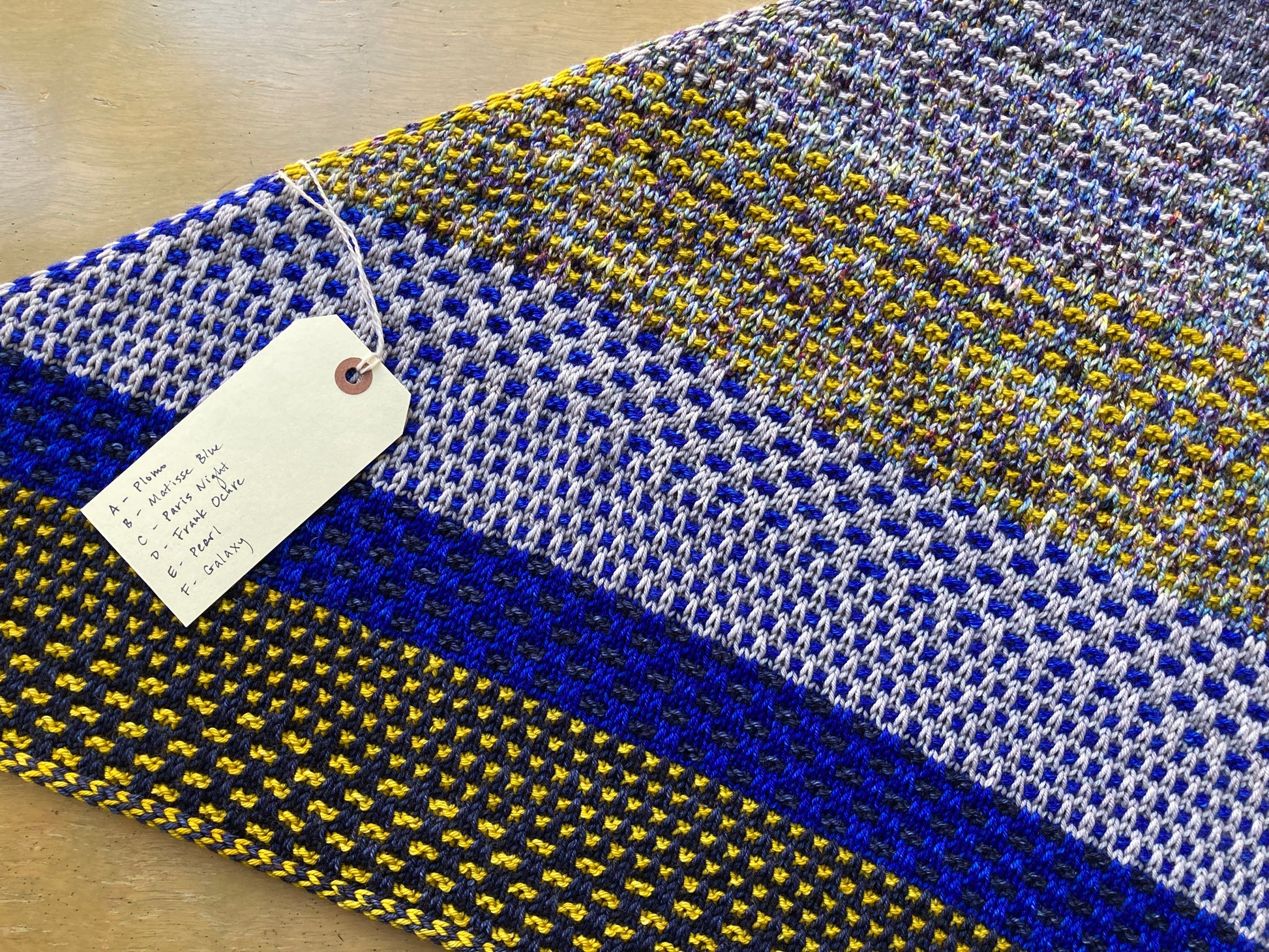 "Nightshift" shawl knit with Malabrigo Caprino in shades of blue, gray, and yellow