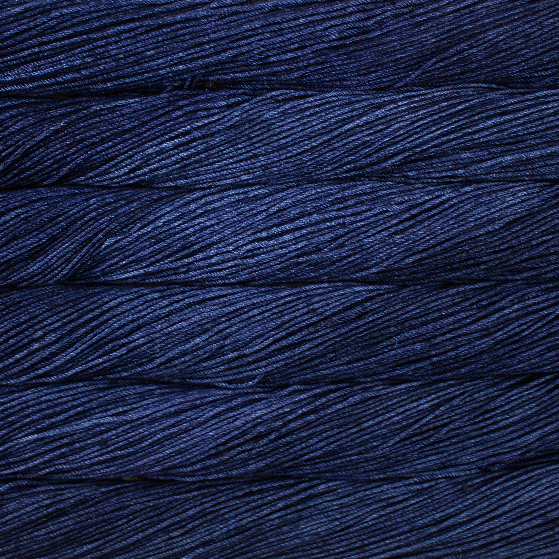 Skein of semisolid dark blue Malabrigo Caprino yarn. 