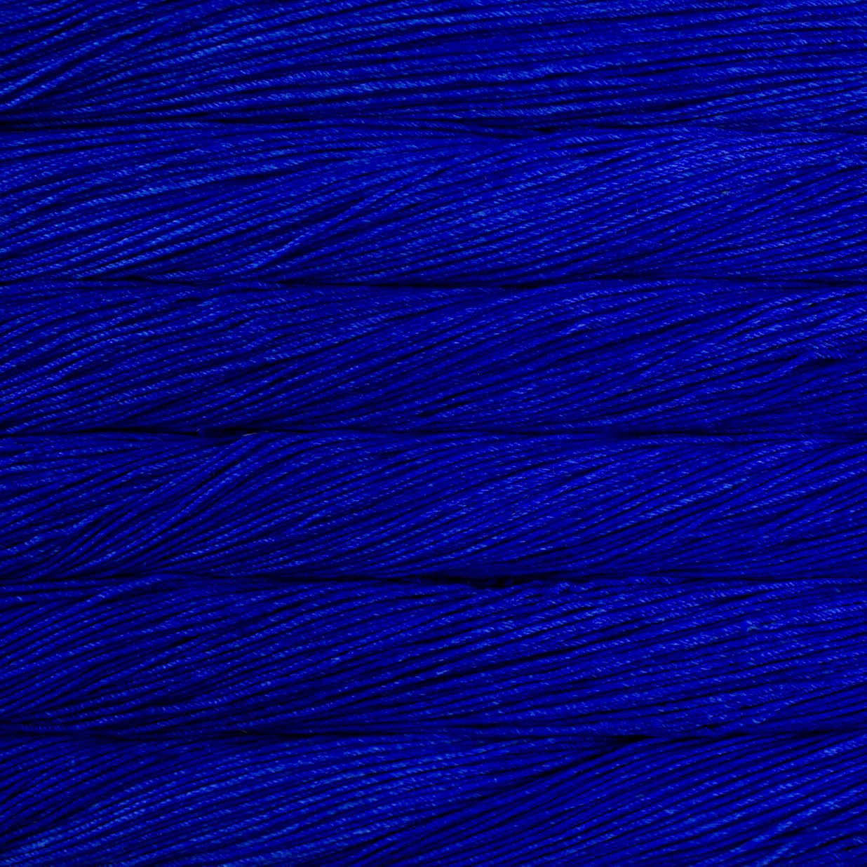 Skein of semisolid cobalt blue Malabrigo Caprino yarn. 