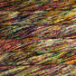 Skein of speckled red, green, and yellow Malabrigo Caprino yarn. 