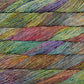 Skein of variegated green, rust, purple and red Malabrigo Caprino yarn. 