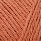 Close up on a terracotta skein of Brown Sheep Cotton Fleece yarn. 