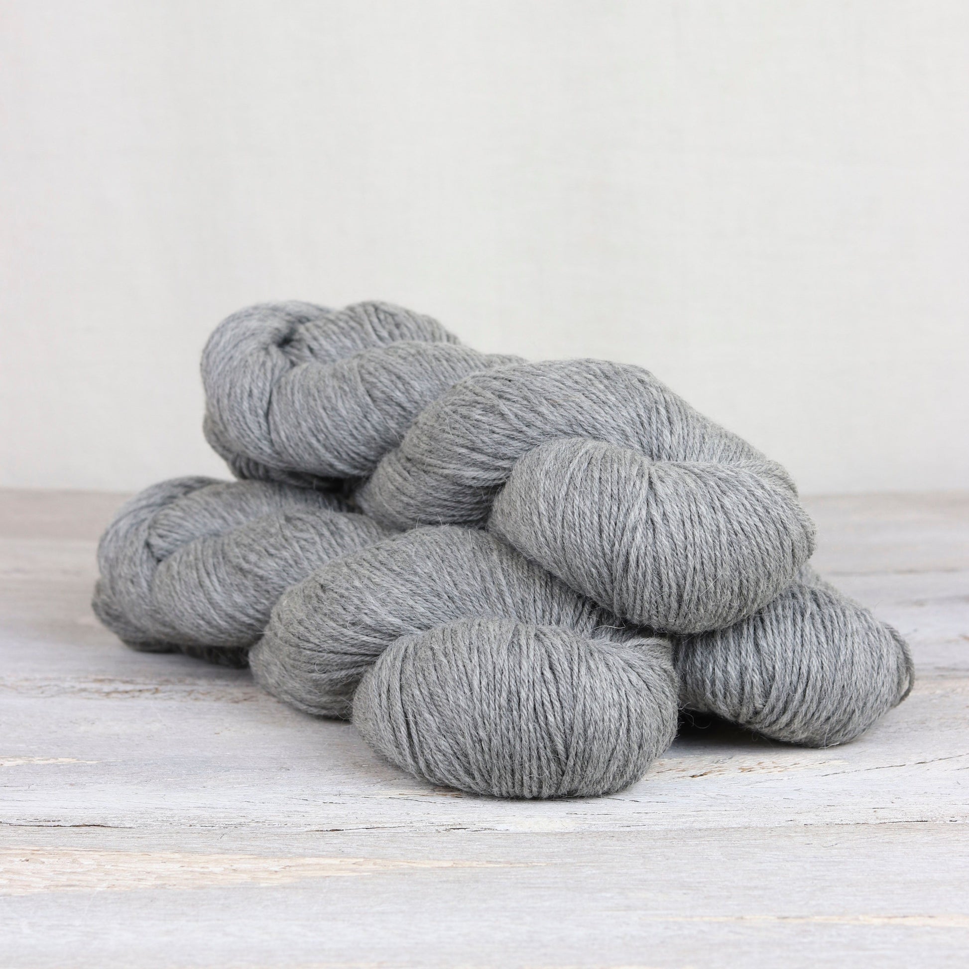 3 skeins of light gray Fibre Co. Cumbria Fingering yarn. 