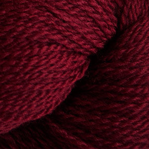 Close up on a burgundy skein of Cascade 220 Fingering yarn. 