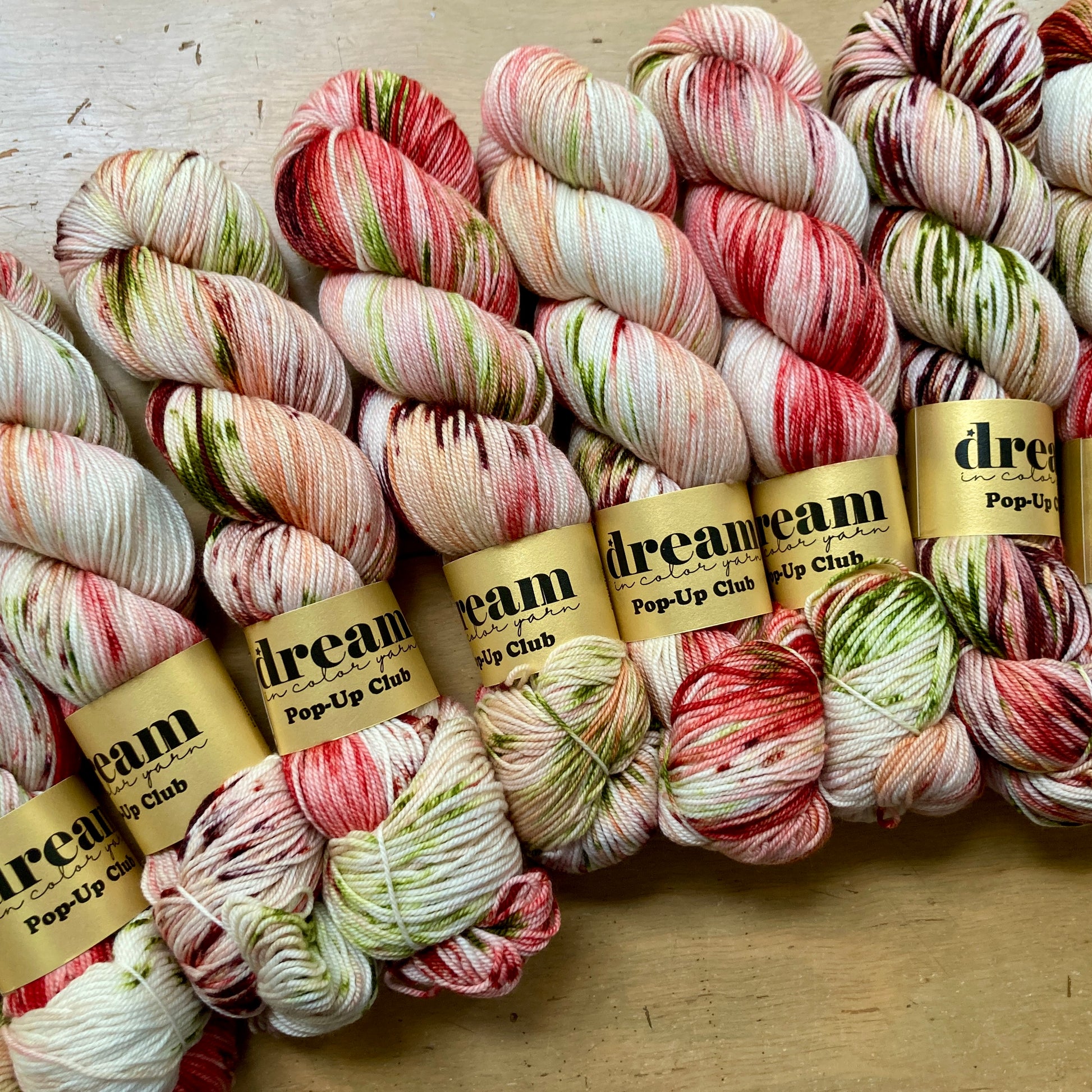 Variegated cream, olive and brick skeins of Dream in Color Smooshy Cashmere yarn. 