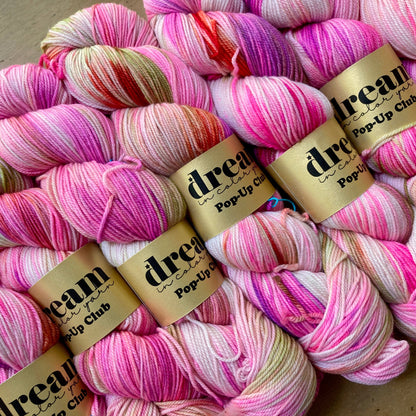 Variegated neon pink and cream skeins of Dream in Color Smooshy Cashmere yarn. 