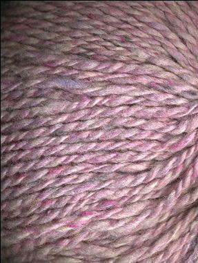 Close up on a light pink tweed ball of Queensland Kathmandu Aran yarn. 