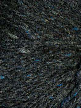 Close up on a dark indigo tweed ball of Queensland Kathmandu Aran yarn. 