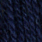 Close up on a dark blue tweed ball of Queensland Kathmandu Aran yarn. 